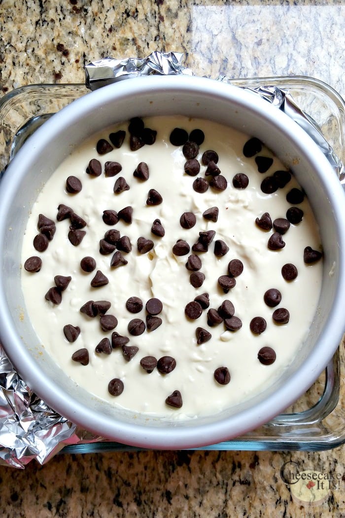 Chocolate chip cheesecake batter in pan