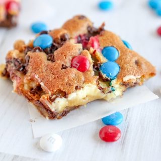M&M Chocolate Chip Cheesecake Bars with red white and blue m&m's on top and around.