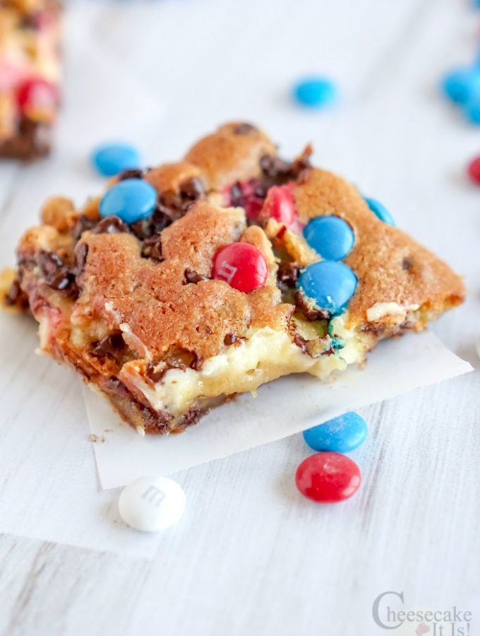 M&M Chocolate Chip Cheesecake Bars with red white and blue m&m's on top and around.