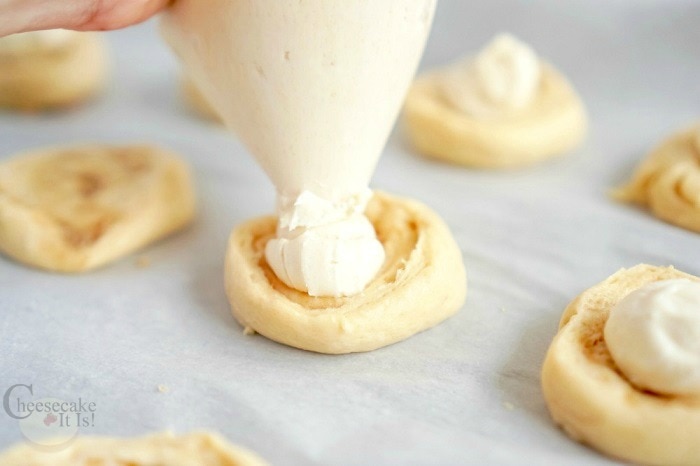 Add cheesecake filling to cut dough rolls