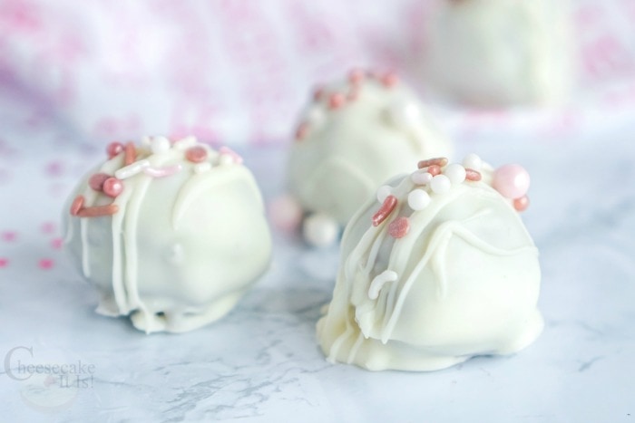 White cheesecake balls with pink sprinkles