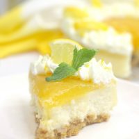 Slice of lemon cheesecake on white plate