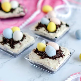 Small dishes of mini egg cadbury cheesecake cups topped with mini eggs