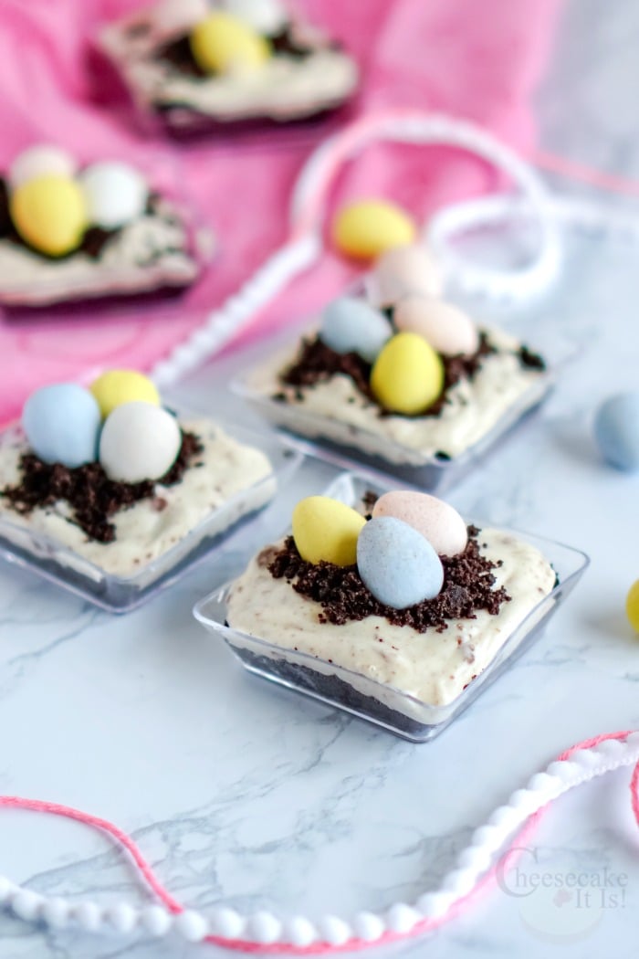 Small dishes of mini egg cadbury cheesecake cups topped with mini eggs