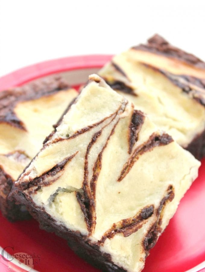 Cheesecake brownies on red plate