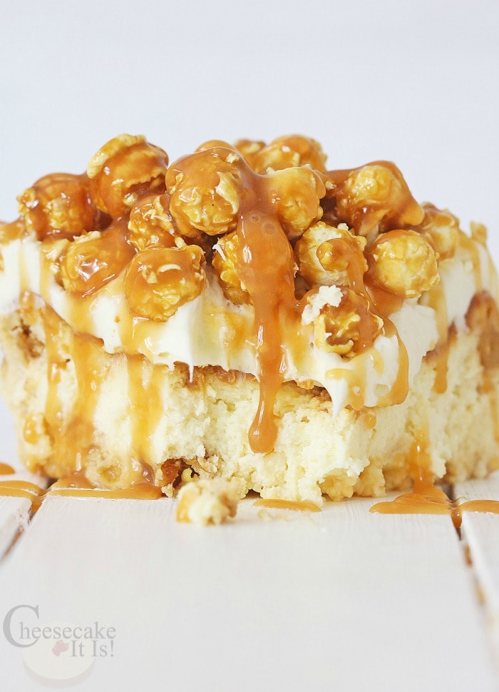 Slice of cheesecake topped with caramel corn and caramel sauce
