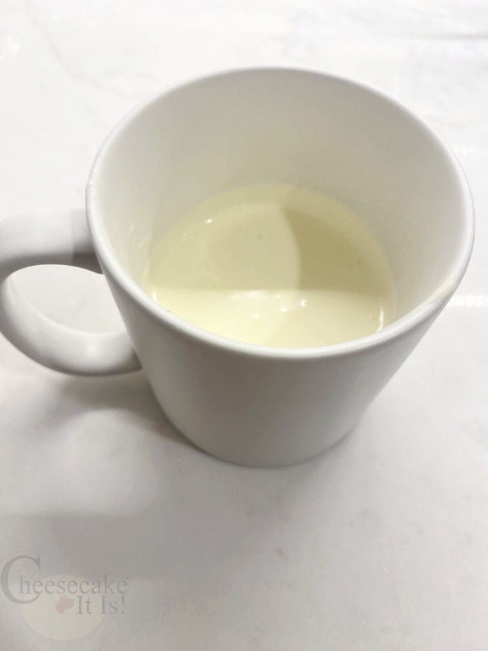 Cheesecake batter in white coffee mug