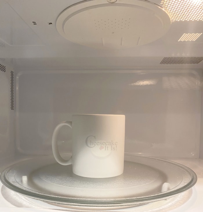 White coffee mug in microwave