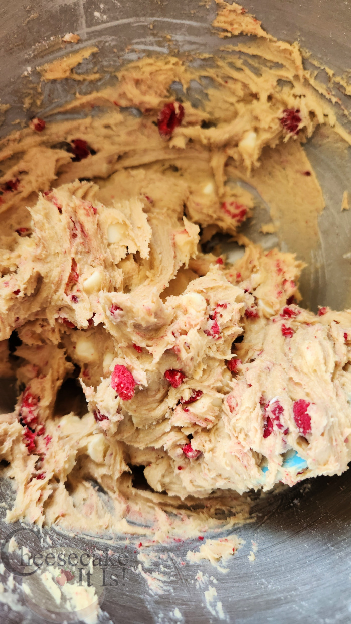 Raspberries and white chocolate chips mixed into cookie dough