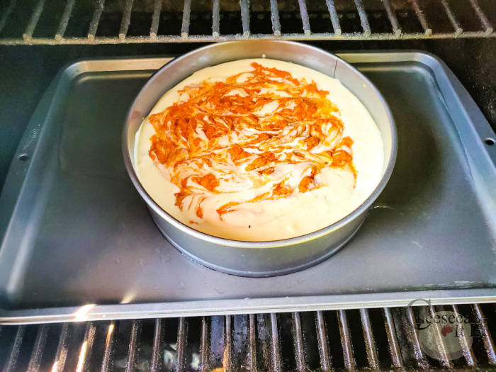 pumpkin swirl cheesecake on pan on grill