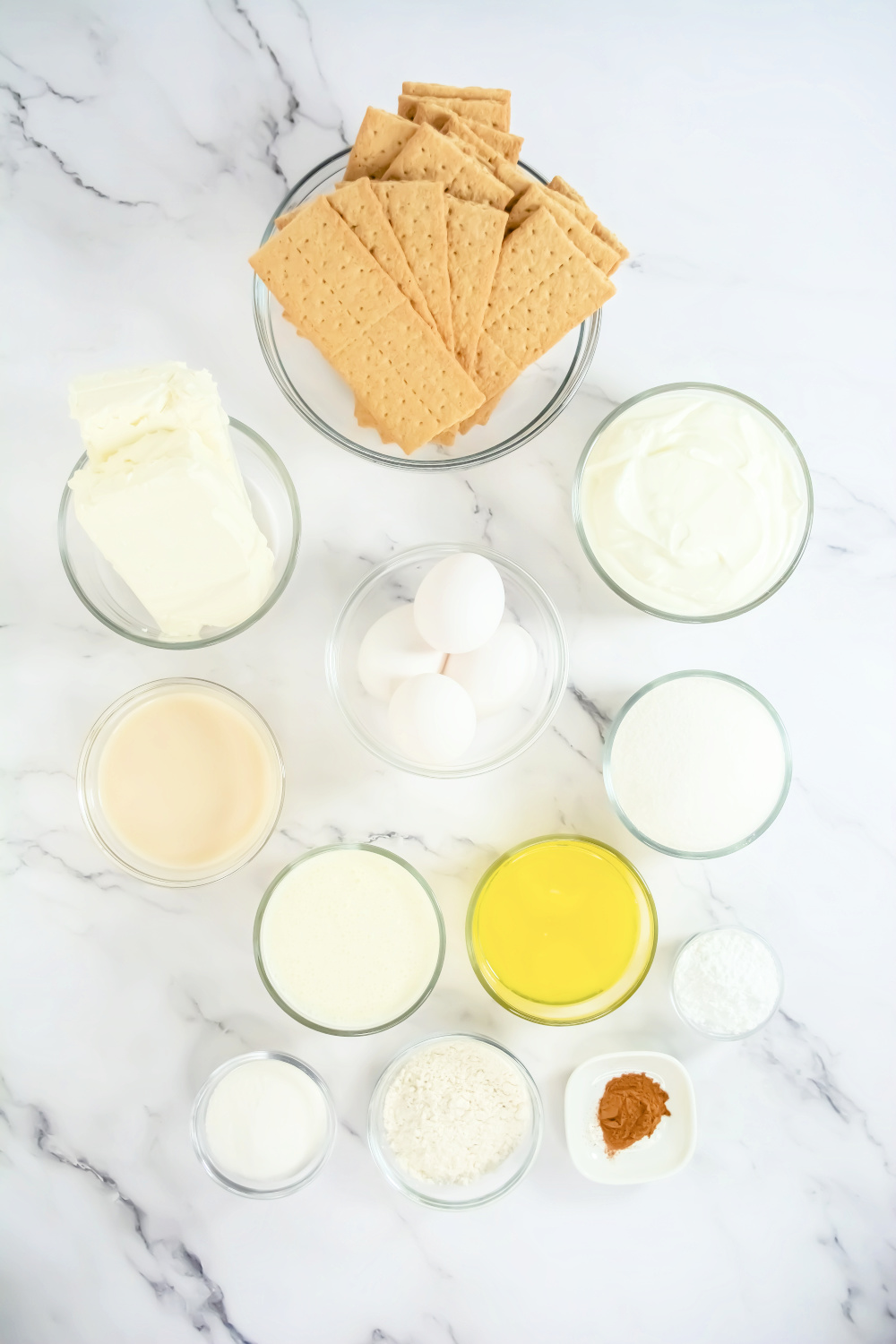 Overhead view of RumChata Cheesecake Ingredients in glass bowls.